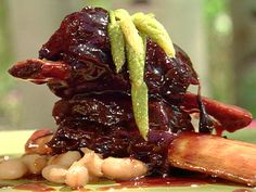 a pile of food sitting on top of a plate covered in beans and meat sauce