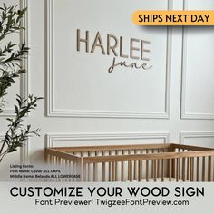 a baby crib in front of a white wall with the words, customize your wood sign