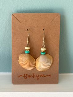 Handmade colorful seashell earrings with real seashells from Myrtle Beach, South Carolina. Earrings are gold and nickel free. Full collection includes different color options to have your very own unique one of a kind pair of real seashell earrings! This pair includes orange seashells with yellow, teal and gold beads. Shell-shaped Jewelry With Matching Earrings For The Beach, Shell-shaped Beach Jewelry With Ear Wire, Shell Earrings For Beach Season Gift, Shell-shaped Earrings For Beach Season Gift, Beachy Shell Dangle Earrings, Handmade Ocean-inspired Earrings For Beach Season, Beach Season Shell Earrings Gift, Handmade Ocean-inspired Earrings For Beach, Bohemian Shell Earrings For Beach Season