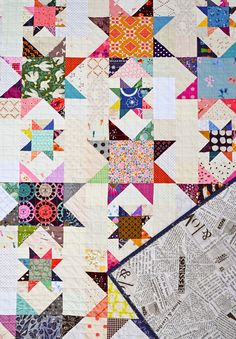 a quilt made with many different colors and patterns on the front, side, and back