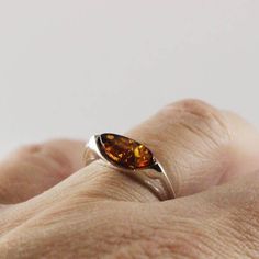 Delicate and beautiful design Baltic Amber ring sideways marquise shape stunning delicate 925 sterling silver baltic amber cabochon set in silver 925 not plated Genuine Baltic sea cognac color Amber ring solid silver 925e not plated Dimensions Amber cab : 11 x 5 mm Length : 15 mm  Width : 6 mm (sideways) Height : 4 mm (thickness) Weight : 2 gr Modern Marquise Cut Jewelry For Gifts, Amber Cabochon Jewelry For Wedding, Elegant Amber Jewelry With Polished Finish, Modern Silver Marquise Jewelry, Modern Baltic Amber Jewelry For Formal Occasions, Modern Marquise Silver Jewelry, Minimalist Silver Marquise Ring, Classic Baltic Amber Jewelry As Gift, Elegant Baltic Amber Jewelry For Formal Occasions