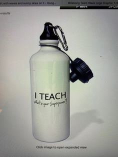 a white water bottle sitting on top of a computer screen next to a keychain