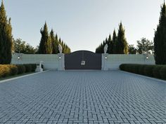 a large driveway with trees and bushes surrounding it