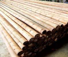 several large bamboo poles stacked on top of each other