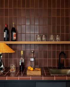 a kitchen counter with bottles and glasses on it