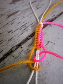 an orange and pink piece of string on wood