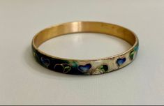 "Fabulous bangle by Taiwanese artist Robert Kuo, brings an organic, modern look to an ancient art. Cool colors of blue, green, purple and cream enamel surround stylized leaves and hearts outlined in gold. Just gorgeous and quite unusual.  Bracelet measures 2 5/8\" inside diameter and 8\" circumference. Listing is offered as-is. Please ask any questions prior to purchasing." Hand Painted Gold Bracelet, Gold Hand Painted Bracelets As Gift, Gold Hand Painted Bracelets For Gift, Hand Painted Gold Bracelets For Gift, Elegant Hand Painted Bracelet, Hand Painted Gold Jewelry Wearable Art, Artistic Hand Painted Jewelry Bracelet, Heart Outline, Colors Of Blue