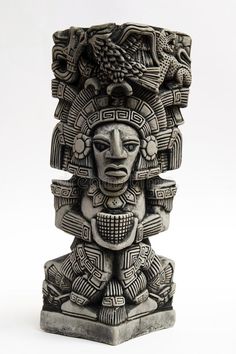 a statue that is made out of clay and has an intricate design on it's face