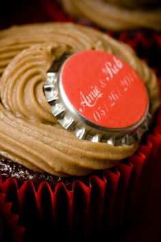 a chocolate cupcake with frosting and a bottle cap on it's top