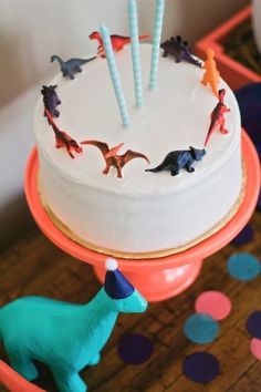 a birthday cake with dinosaur decorations on it