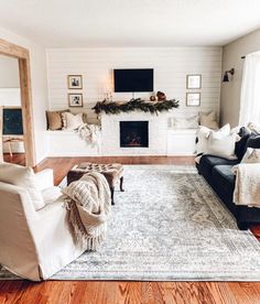 a living room filled with furniture and a fire place in the middle of the room