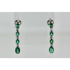 This is part of Chairish’s Fine Jewelry assortment.  Emerald Drop Dangle Earrings 18K  These lovely Emerald Drop Earrings are done in 18K White Gold and is set with 4 Emeralds each, 6 Diamonds of 0.15 points each, 3 Emeralds of approximately 1/2 Carat each and the bottom Emerald 1 carat each. TCW is 5 carats. The length of these earrings are 4 cm and it weighs 7.9 grams. This earrings are a nice addition to your Emerald wardrobe as they are simple drop Earrings and the Emeralds are of nice color Elegant Green Diamond Dangle Earrings, Elegant Green Dangle Diamond Earrings, Green Linear Drop Earrings For Formal Occasions, Classic Hand Set Drop Earrings, Timeless Hallmarked Dangle Earrings, Classic Hand Set Dangle Earrings, Elegant Green Dangle Linear Earrings, Timeless Green Earrings For Formal Occasions, Timeless Green Earrings For Formal Events