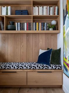 a room with bookshelves and a bench in it