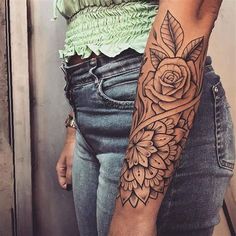 a woman with a rose tattoo on her arm