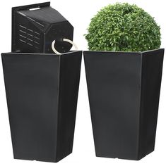 two large black planters sitting next to each other