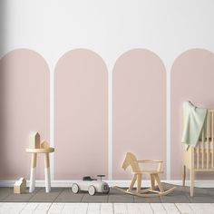 a baby's room with pink and white walls