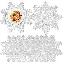 an image of a table setting with place settings and snowflakes on the table