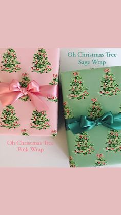 two christmas tree boxes with bows on them, one is green and the other is pink