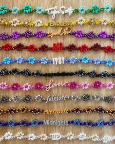 a bunch of different colored hair ties on a wooden table with the words love written in it