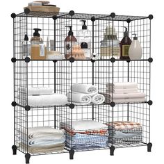 an iron wire shelving unit with towels and soaps