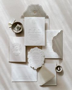 the wedding stationery is laid out on top of the bed