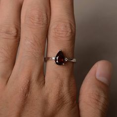 This is a gorgeous handmade creation. Its beauty is its simplicity & Elegance. The 6*9 mm pear shape faceted natural garnet is crafted in solid sterling silver and with rhodium plated. All item is sent in a beautiful gift box If you have any idea of design your ring,pls contact me directly. You can realize more lovely stuff clicking the link https://www.etsy.com/shop/knightjewelry?refshopsection_shophome_leftnav Please leave the correct address and you phone number for delivering successfull Ruby Ring Designs, Garnet Stone Ring, Cute Promise Rings, Red Gemstone Ring, January Birthstone Rings, Red Garnet Ring, Birthday Ring, Red Gemstones, January Birthstone