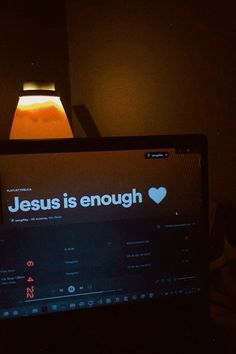 a computer screen with the words jesus is enough on it in front of a lamp