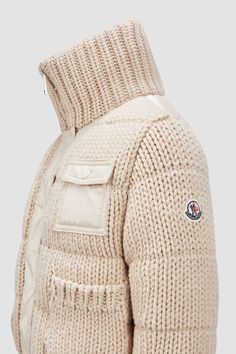 Designed to protect little ones from the elements, this heavy knit cardigan is crafted from plush wool. The zip-up design is enhanced with a down-filled back, allowing the style to double as outerwear in milder weather. Wool Outerwear With Ribbed Cuffs In Cream, Cream Wool Outerwear With Ribbed Cuffs, Beige Wool Knitted Outerwear, Cream Knitted Wool Outerwear, Cozy White Merino Wool Outerwear, Cozy Cream Merino Wool Outerwear, Cream Wool Chunky Knit Outerwear, White Knitted Wool Outerwear, White Wool Knitted Outerwear