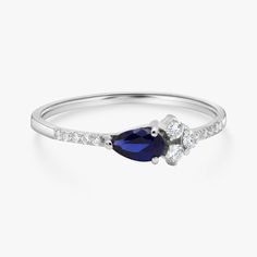 Sleek and sophisticated cluster ring set with a pear cut Sapphire and diamonds. This rings is dainty and full of charm! The Sapphire is highlighted perfectly by the surrounding diamonds engulfing it in flashes of diamonds sparkle from every angle. -Made to Order, perfectly finished, Fast shipping fully insured and traceable online. -Gemstone info: 5 x 3 mm pear cut Blue corundum Sapphire , Excellent cut, 0.25 ct -Diamond info: 2 x Diamonds 1.75 mm, Round Brilliant cut, VS-E 0.05 ct 1 x Diamond 1 Blue Cluster Diamond Ring, Cluster Ring Set, Ring Sapphire, Sapphire Diamond Ring, Ring Blue, Diamond Cluster Ring, Ring Diamond, Multi Stone Ring, Blue Gemstones