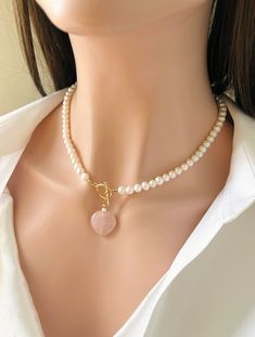 Elegant Freshwater White Pearl Necklace in 14K Goldfilled  Toggle Clasp . Beautiful accessory for Work , Party or for any Occasion  . Semi Round Pearls with Subtle Pink Rosequartz Heart Pearl Size : 8-9 mm Heart Size : 1 inch approx  Necklace length : 18 inches For matching bracelet pls see link below : https://etsy.me/3kkqVcy Pink Pearl Charm Jewelry For Valentine's Day, Valentine's Day Pink Jewelry With Pearl Charm, Valentine's Day Pink Pearl Charm Jewelry, Elegant Heart-shaped Gemstone Bead Jewelry, Feminine Heart Beads Jewelry For Wedding, Valentine's Day Jewelry Making Gemstone Beads, Round Natural Stones Jewelry For Valentine's Day, Round Natural Stone Jewelry For Valentine's Day, Valentine's Day Gemstone Beads Jewelry Gift