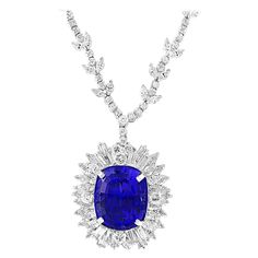 This extraordinary, 43 carat tanzanite is truly an extraordinary gemstone. There are total of 18 carats of shimmering white diamonds, this brilliant cushion-cut gem exhibits the rich violetish-blue color for which these stones are known and so highly treasured. The clear, intense hue of this tanzanite is the most coveted of all these rare stones. In fact, deep blue tanzanites such as this one are worth more per carat than the more common light purple hues, as it is highly unusual to see this uni Ruby And Diamond Necklace, Drop Necklaces, Cascade Necklace, Real Diamond Necklace, Tanzanite Pendant, Tanzanite Necklace, Tanzanite Jewelry, Girl Accessories, Detailed Necklace