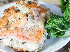 a white plate topped with shrimp and broccoli