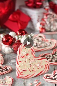 valentine's day cookies are arranged on a table with candy canes and ornaments