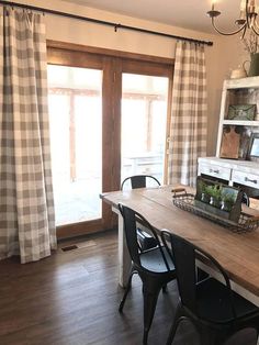 the dining room table is set with black chairs