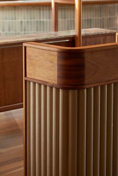 an office desk with wooden slats on the top