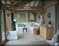 a living room filled with white furniture and lots of lights on the windows sill