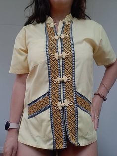 This beauty has been kept in storage since the 70s . It's a traditional Chinese chasing style blouse, material is cotton and buttons are beautifully made.  This is a handmade item with embroidered ethnic detail. Blouse is fitted and has side splits. . Condition - great just a couple of faint marks and one stain pictured in front pocket. . Measurements taken lying flat . Bust - 47cm Waist - 44cm Length - 63cm Traditional Cotton Top With Stand Collar, Traditional Fitted Tops With Motif, Traditional Stand Collar Top With Buttons, Fitted Traditional Motif Tops, Traditional Motif Fitted Top, Traditional Stand Collar Tops For Spring, Traditional Spring Tops With Stand Collar, Traditional Spring Top With Stand Collar, Traditional Fitted Tops With Stand Collar