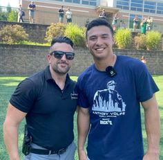 two men standing next to each other on a field