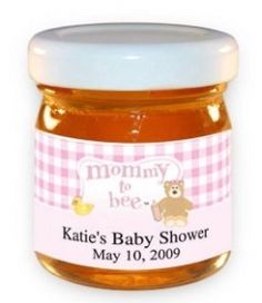 a jar of baby shower honey with a teddy bear on the front and pink checkered label