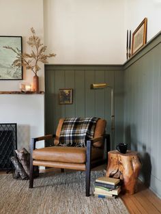 a living room filled with furniture and a fire place next to a wooden floor covered in books