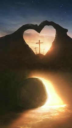 a heart shaped rock with a cross in the background