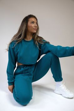 Pea Street has handmade the best quality loungewear for you peas. This teal blue crop brush back sweatshirt jumper is super cute to go with the matching joggers and crop top. Ribbed collar and cuffs. model size 8-10 wearing size 10 handmade to order, high quality fabric. Sporty Crop Top For Loungewear With Cropped Hem, Trendy Cropped Sweater With Ribbed Cuffs For Loungewear, Casual Cropped Top For Lounging, Blue Cropped Crop Top For Loungewear, Blue Cropped Top For Loungewear, Relaxed Fit Crop Top For Loungewear, Relaxed Fit Long Sleeve Crop Top For Loungewear, Casual Blue Crop Top For Loungewear, Winter Loungewear Crop Top With Crew Neck