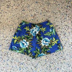 Hand made shorts using Vintage Hawaiian  fabric, in a tropical floral print in greens and blues, Small Waist 25" stretches to 38"  Hips 41"  Rise 13" Inseam 3" Mid waisted fit  with  contrasting side seam pockets  Elastic waist band   *fabric is repurposed may have slight wear . Each of these shorts are one of a kind with unique placement of fabric and colors.       cotton fabric, machine wash cold delicate  or hand wash cool dryer or hang dry  From the Kiki42  label, handmade in Los Angeles CA. Hawaiian Summer Bottoms Short Length, Hawaiian Style Shorts For Beach Season, Hawaiian Style Summer Bottoms In Short Length, Hawaiian Bottoms With Built-in Shorts For Beach Season, Hawaiian Style Summer Shorts, Blue Hawaiian Style Bottoms For Summer, Hawaiian Style Blue Bottoms For Summer, Blue Hawaiian Summer Bottoms, Hawaiian Style Blue Summer Bottoms