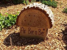 a wooden sign that says airbee'n bee on it in front of some flowers