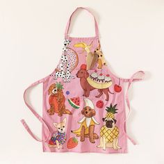 a pink apron with dogs and fruits on it