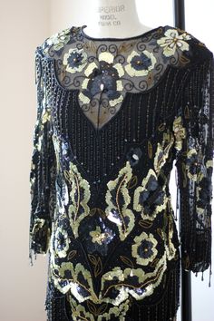 "Beautiful Beaded sequined Dress!! This is all silk...has a see through neck...with beads...and hanging beaded fringe throughout..just the right amount! Absolutely in Excellent condition with zip up back..oh wow this is a beauty!! Measuring: 45\" length Bust: 38\" Waist: 28\" Hip: 38\" Sleeves:22\" Beautiful!! Pet Free/smoke free Enjoy!" Fitted Embellished Flapper Dress For Festive Occasions, Festive Fitted Embellished Flapper Dress, Festive Embellished Fitted Flapper Dress, Glamorous Floor-length Flapper Dress For Party, Floor-length Embellished Sequin Cocktail Dress, Beaded Fringe Fitted Flapper Dress For Wedding, Fitted Beaded Fringe Flapper Dress For Wedding, Fitted Glamorous Floor-length Flapper Dress, Fitted Floor-length Glamorous Flapper Dress