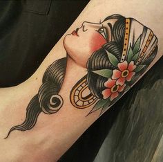 a woman's arm with a tattoo on it and an image of a geisha