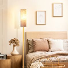 a bed room with a neatly made bed next to a night stand and a lamp