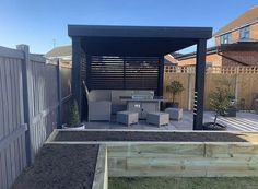 a backyard with a grill and seating area