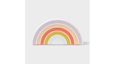 a rainbow sticker sitting on top of a white surface